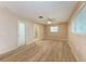 This bedroom features wood-look flooring, a ceiling fan and an ensuite at 402 Ravenna N St, Nokomis, FL 34275