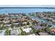 An aerial view of a waterfront neighborhood featuring well-maintained homes with boat docks and lush tropical landscaping at 432 Partridge Cir, Sarasota, FL 34236