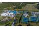Aerial view of community pool, tennis courts, and park area near beautiful homes at 4440 Fairways Blvd # 407, Bradenton, FL 34209