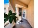 Balcony features a white front door, a welcome mat, and a potted plant at 4440 Fairways Blvd # 407, Bradenton, FL 34209