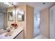 Bright bathroom features a large mirror, neutral countertops, and white tile floors at 4440 Fairways Blvd # 407, Bradenton, FL 34209