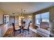 Open-concept dining area with seating and views into the living areas of the home at 4440 Fairways Blvd # 407, Bradenton, FL 34209