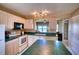 Well-lit kitchen with light wood cabinets, green countertops, and a pass-through to the dining area at 4440 Fairways Blvd # 407, Bradenton, FL 34209