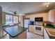 Bright kitchen featuring light wood cabinets, green countertops, and a center island at 4440 Fairways Blvd # 407, Bradenton, FL 34209