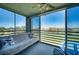 Sunroom/lanai with scenic golf course views from large sliding windows and cozy seating at 4440 Fairways Blvd # 407, Bradenton, FL 34209