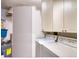 Practical laundry area equipped with a washer, dryer, storage cabinets, and water heater at 4440 Fairways Blvd # 407, Bradenton, FL 34209