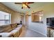 Cozy living room featuring a ceiling fan, neutral decor, and an open view into the kitchen at 4440 Fairways Blvd # 407, Bradenton, FL 34209