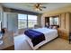 Inviting bedroom boasts a large window overlooking the golf course, with built-in storage and a plush bed at 4440 Fairways Blvd # 407, Bradenton, FL 34209