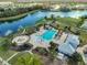 Aerial view of community pool, playground, and lake, offering recreational opportunities and scenic views at 4516 Renwick Dr, Parrish, FL 34219