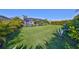 Expansive backyard featuring a lush green lawn with manicured landscaping and a screened-in pool area at 4516 Renwick Dr, Parrish, FL 34219