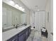 Bathroom features a long vanity with modern fixtures, and a shower with a curtain at 4516 Renwick Dr, Parrish, FL 34219