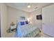 Cozy bedroom featuring a ceiling fan, an accent wall, and a bed with a blue patterned comforter at 4516 Renwick Dr, Parrish, FL 34219