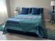 Comfortable bedroom featuring a bed with a beautiful patterned quilt, and stylish side tables at 4516 Renwick Dr, Parrish, FL 34219