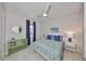 Comfortable bedroom features a patterned bedspread, side table, and ample natural light at 4516 Renwick Dr, Parrish, FL 34219