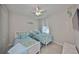 Charming bedroom with two twin beds, ceiling fan, and a mounted TV for cozy relaxation at 4516 Renwick Dr, Parrish, FL 34219