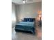 Bright bedroom featuring a bed with a blue patterned quilt, and side tables adorned with lamps at 4516 Renwick Dr, Parrish, FL 34219