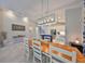 Dining area showcases elegant lighting, connecting to an open kitchen with breakfast bar seating at 4516 Renwick Dr, Parrish, FL 34219