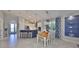 Open-concept dining area with a view of the modern kitchen and a stylish display shelf at 4516 Renwick Dr, Parrish, FL 34219