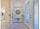 Bright foyer featuring neutral tones, decorative mirror, console table and a view into the kitchen at 4516 Renwick Dr, Parrish, FL 34219