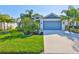 Beautiful single-Gathering home featuring a well-manicured lawn and vibrant blue two-car garage door at 4516 Renwick Dr, Parrish, FL 34219