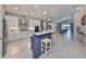 Open-concept kitchen featuring stainless steel appliances, a large island, and seamless flow to living areas at 4516 Renwick Dr, Parrish, FL 34219