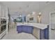 Open kitchen with stylish blue cabinetry, stainless steel appliances, and breakfast bar seating at 4516 Renwick Dr, Parrish, FL 34219