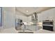 Modern kitchen with white cabinets, stainless steel appliances, and a stylish backsplash at 4516 Renwick Dr, Parrish, FL 34219