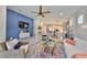 Open concept living room with comfortable seating and ample natural light, ceiling fan, and television at 4516 Renwick Dr, Parrish, FL 34219