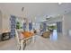 Bright living room with dining area, ceiling fan, and sliding doors to the lanai at 4516 Renwick Dr, Parrish, FL 34219