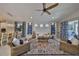 Sunlit living room with stylish furnishings, an area rug, and a seamless flow to the outdoors at 4516 Renwick Dr, Parrish, FL 34219