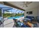 Inviting covered patio with comfortable seating, outdoor television, and view of the sparkling pool at 4516 Renwick Dr, Parrish, FL 34219