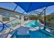 Inviting screened-in pool area with comfortable seating under a large blue umbrella, perfect for summer days at 4516 Renwick Dr, Parrish, FL 34219