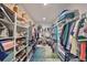 Spacious walk-in closet with an abundance of shelves, rods, a built-in desk, and a colorful rug at 4516 Renwick Dr, Parrish, FL 34219