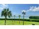 Picturesque water view framed by tropical palms and vibrant green lawn at 4600 Gulf Of Mexico Dr # 202, Longboat Key, FL 34228