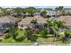 Aerial view of home featuring a screened lanai and tropical landscaping at 4616 Blue Marlin Dr, Bradenton, FL 34208