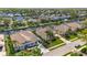 Aerial view of canal-front homes featuring pools and boat docks on a sunny day at 4616 Blue Marlin Dr, Bradenton, FL 34208