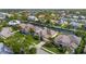 Aerial view of waterfront community showcases homes with canals, docks, and lush landscaping at 4616 Blue Marlin Dr, Bradenton, FL 34208