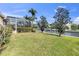 Landscaped backyard with fenced canal access from the screened lanai at 4616 Blue Marlin Dr, Bradenton, FL 34208