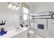 Well-lit bathroom featuring a shower with glass doors, and sink with modern fixtures at 4616 Blue Marlin Dr, Bradenton, FL 34208