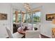 Bright breakfast nook features a round wood table with pool views through sliding glass doors at 4616 Blue Marlin Dr, Bradenton, FL 34208