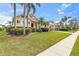 Landscaped front yard leading to a charming single-Gathering home with attached garage and portico at 4616 Blue Marlin Dr, Bradenton, FL 34208