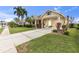Well-kept single Gathering home with lush landscaping, palm trees, and a spacious driveway at 4616 Blue Marlin Dr, Bradenton, FL 34208