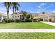 Charming single-story home with lush landscaping, a well-manicured lawn, and a porte-cochere at 4616 Blue Marlin Dr, Bradenton, FL 34208