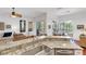 Open kitchen featuring a breakfast bar, stainless steel sink, and views of the living area and outdoor patio at 4616 Blue Marlin Dr, Bradenton, FL 34208