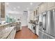 Kitchen features a stainless steel fridge, gas range, and granite countertops at 4616 Blue Marlin Dr, Bradenton, FL 34208