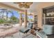 Inviting screened lanai featuring brick flooring, comfortable seating, and a ceiling fan at 4616 Blue Marlin Dr, Bradenton, FL 34208