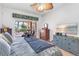Bright main bedroom features a ceiling fan, sliding glass doors to the lanai, and stylish furniture at 4616 Blue Marlin Dr, Bradenton, FL 34208