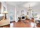 An office space with a fireplace, chandelier, and tile floors creates an inviting and functional work environment at 4616 Blue Marlin Dr, Bradenton, FL 34208