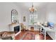 Bright home office with white furniture, fireplace, and large window with shutters for natural light at 4616 Blue Marlin Dr, Bradenton, FL 34208