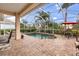 Covered pool area with outdoor seating and manicured landscaping offer a relaxing experience at 4616 Blue Marlin Dr, Bradenton, FL 34208